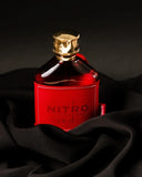 Bottle of Nitro red whiskey with a gold cap on black fabric background