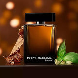 Dolce & Gabbana perfume bottle with basil leaves on a warm-toned background