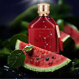 Red Nitro perfume bottle with watermelon slices on a dark background